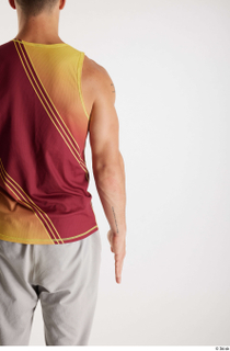 Darren  1 arm back view dressed flexing red-yellow tank…